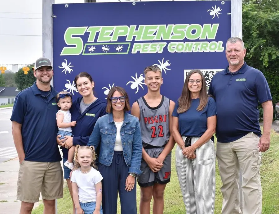 The Stephenson family in front of the Stephenson Pest Control sign